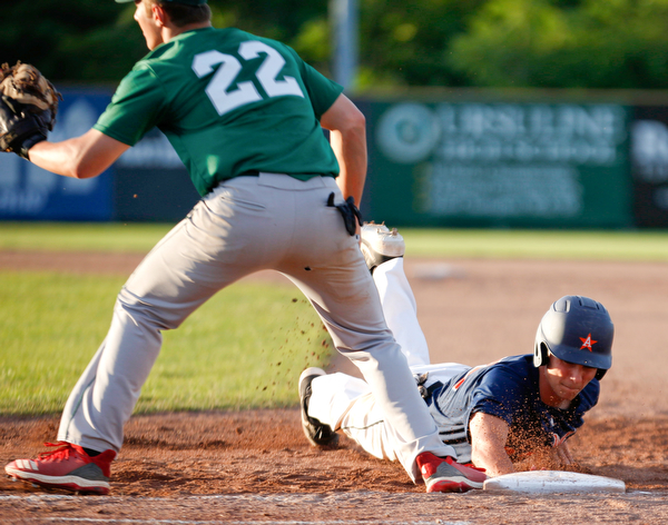 The Astro Falcons' Lucas Gulczynski dives back to first before the Stark County Terriers' Dalton Frey could tag him during their game at Bob Cene Park on Sunday. EMILY MATTHEWS | THE VINDICATOR