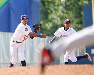 Scrappers' Jonathan Lopez, left, throws the ball to first during their game against the Muckdogs at Eastwood Field on Sunday afternoon. EMILY MATTHEWS | THE VINDICATOR