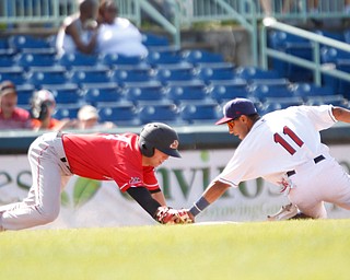 Scrappers' Brayan Rocchio tries to tag Muckdogs' Kobie Taylor out at third during their game at Eastwood Field on Sunday afternoon. EMILY MATTHEWS | THE VINDICATOR