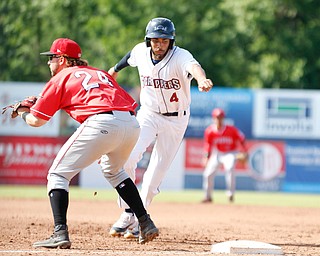 Scrappers' Michael Cooper runs back to first before Muckdogs' Harrison Dinicola could tag him during their game against the Muckdogs at Eastwood Field on Sunday afternoon. EMILY MATTHEWS | THE VINDICATOR