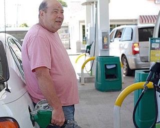 Mark Anderson of Zelienole, Pa., fills up at the Tic Toc Foods BP gas station along U.S. Route 422 in Lowellville, which charged $2.69 per gallon of regular unleaded fuel Monday afternoon. Anderson is one of several Pennsylvanians who said they skip across the state line for cheaper fuel, as Pennsylvania has the highest gas tax rate in the nation. Ohio's increased gas tax became effective Mond