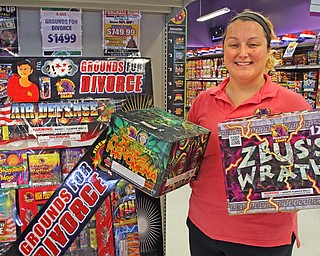 Carlee Phelan, manager of the Phantom Fireworks store on Meridian Road, shows off two of the store’s top sellers. Fireworks will be going off throughout the Mahoning and Shenango valleys to celebrate our nation’s birthday. 