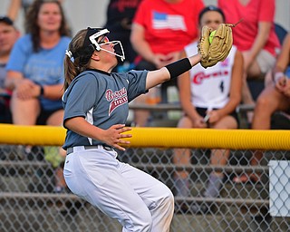 BOARDMAN, OHIO - JULY 2, 2019: Boardman's Olivia LaCivita catches a fly ball for the out in foul territory in the second inning of their game, Tuesday night against Boardman at the Field of Dreams. Canfield's Marina Koenig would be out on the play. Canfield won 6-1. DAVID DERMER | THE VINDICATOR