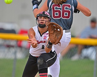 BOARDMAN, OHIO - JULY 2, 2019: Canfield's Katie Koulianos looks the ball into her glove after a infield RBI single by Boardman's Lilly Ditz in the third inning of their game, Tuesday night against Boardman at the Field of Dreams. Canfield won 6-1. DAVID DERMER | THE VINDICATOR