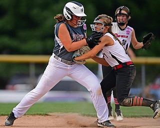 BOARDMAN, OHIO - JULY 2, 2019: Canfield's Katie Koulianos, left, is tagged out by Canfield's Caley Salley after attempting to steal second base in the third inning of their game, Tuesday night against Boardman at the Field of Dreams. Canfield won 6-1. DAVID DERMER | THE VINDICATOR