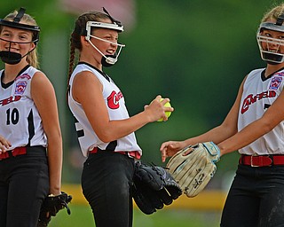 BOARDMAN, OHIO - JULY 2, 2019: Canfield's Paris Lindgren, center, is congratulated by Caley Selley, right, and Sami Economos, left, after an out in the fifth inning of their game, Tuesday night against Boardman at the Field of Dreams. Canfield won 6-1. DAVID DERMER | THE VINDICATOR