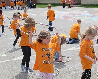 Neighbors | Jessica Harker .Kindergarten students at AES played with hullahoops during their annual Fun Day celebration May 15 outside of the school.