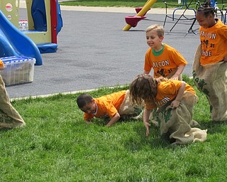 Neighbors | Jessica Harker .Students at Austintown Elementary School competed in a potatoe sack race during the schools kindergarten Fun Day May 15.