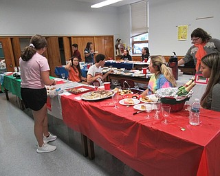 Neighbors | Jessica Harker.Seventh graders at St. Christine's brought food to school May 23 for the school's annual International Day celebration.