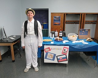 Neighbors | Jessica Harker.PJ Scott, a seventh grade student at St. Christine's, dressed up for the school's annual International Day celebration, posing next to his groups table celebrating his Slovakian heritage.