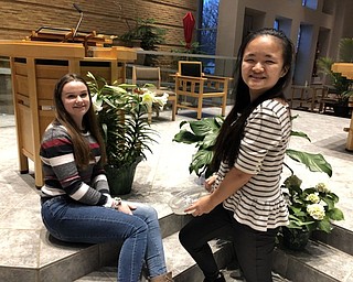 Neighbors | Submitted.Gemma Kearns and Margaret Faur took a break from their Holy Family Youth Ministry duties of decorating the church for Easter.