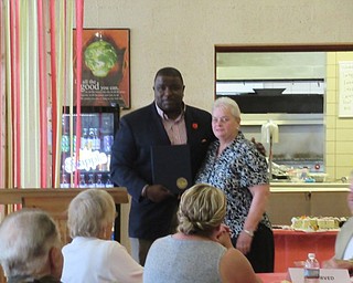 Neighbors | Jessica Harker.Mayor Jamael Brown posed with retiring teacher Nancy Shugart after honoring her 56 years of teaching at the Cardinal Mooney retirement luncheon.
