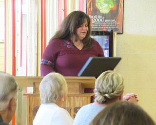 Neighbors | Jessica Harker.Cardinal Mooney Assistant Principal Teresa Yarger accepted a gift honoring her last day as assistant principal before moving to be principal of St. Charles next year.