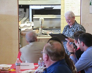 Neighbors | Jessica Harker.Retiring teacher Nancy Shugart admired a gift given to her at Cardinal Mooney's retirement luncheon on June 4.