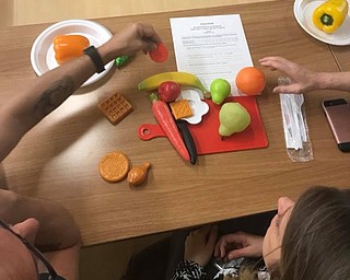 Neighbors | Submitted.Community members learned about balancing healthy meals at the Austintown Farmers Market's free nine week program on Food Wellness hosted by Robin Adams with the Ohio State Expanded Food and Nutrition Education Program.