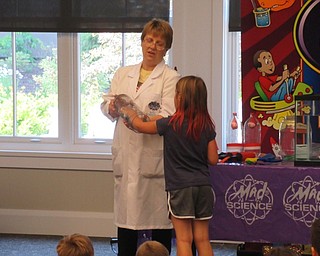 Neighbors | Jessica Harker .Volunteers were called forward to help with various science experiments performed by Mad Science representatives at the Canfield library June 28.