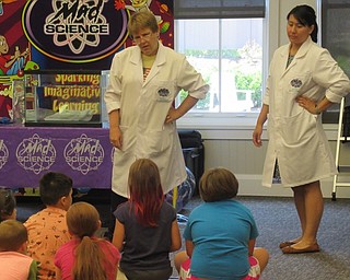 Neighbors | Jessica Harker .Tammy and Camilla from Mad Science talked with children gathered at the Canfield library June 28.