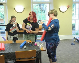 Neighbors | Jessica Harker .Teens used duct tape and pool noodles to create their own lightsabers at the Poland library June 25.