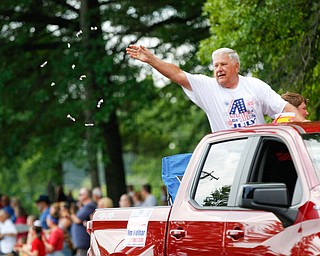 Jim Molnar, an Austintown businessman and the grand marshall of the parade, tosses candy during the Austintown Fourth of July parade on Raccoon Road Thursday afternoon. EMILY MATTHEWS | THE VINDICATOR