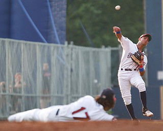 Scrappers' Brayan Rocchio throws the ball over Henderson De Oleo during their game against the Spikes at Eastwood Field on Thursday. EMILY MATTHEWS | THE VINDICATOR