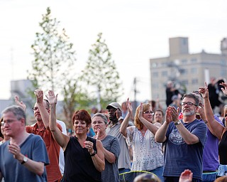 People in the crowd clap and dance as Earth, Wind & Fire perform at the Youngstown Foundation Amphitheatre Friday night. EMILY MATTHEWS | THE VINDICATOR