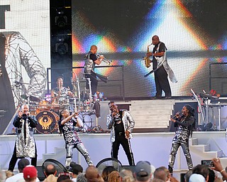 Philip Bailey, center, belts out one of the hits from legendary R&B, pop-funk band Earth, Wind & Fire at the Youngstown Foundation Amphitheatre on Friday night. EW&F hits include “Reasons,” “Shining Star,” “September,”  “Boogie Wonderland,” and “Keep Your Head to the Sky.”