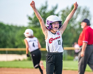 DIANNA OATRIDGE | THE VINDICATOR  Canfield's Brooke Opalick (13) reacts  as her teammate Riley Billack (4) runs the bases after hitting a home run against Howland during the 10U tournament in Boardman on Friday.