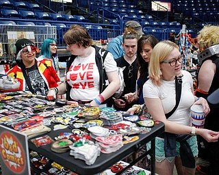 People look at various comic and cartoon-related patches at the Youngstown Comic Con in Covelli Centre on Saturday afternoon. EMILY MATTHEWS | THE VINDICATOR