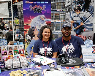 Vesenia Lindsey, the creator of the comic Celestial Pulse, poses for a photo with her husband Justin Lindsey at the Youngstown Comic Con in Covelli Centre on Saturday afternoon. EMILY MATTHEWS | THE VINDICATOR