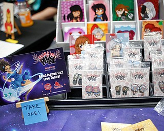 Earrings of characters from Celestial Pulse, a comic made by Vesenia Lindsey, of Youngstown, are on sale along with other merchandise related to the comic at the Youngstown Comic Con in Covelli Centre on Saturday afternoon. EMILY MATTHEWS | THE VINDICATOR