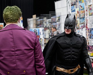 Dirk Granger, of Mineral Ridge, dressed as Batman, walks past another cosplayer dressed as the Joker at the Youngstown Comic Con in Covelli Centre on Saturday afternoon. EMILY MATTHEWS | THE VINDICATOR