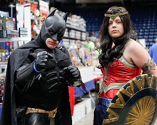 Dirk Granger, left, dressed as Batman, and his daughter Kya Granger, dressed as Wonder Woman, both of Mineral Ridge, pose for a photo at the Youngstown Comic Con in Covelli Centre on Saturday afternoon. EMILY MATTHEWS | THE VINDICATOR