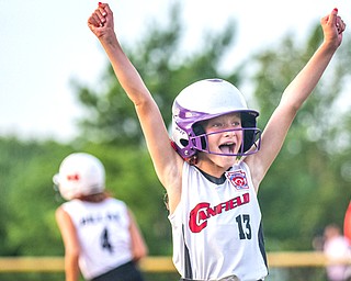 Canfield's Brooke Opalick, 13, reacts as her teammate Riley Billak, 4, runs the bases after hitting a home run against Howland during the 10U tournament in Boardman on Friday.
