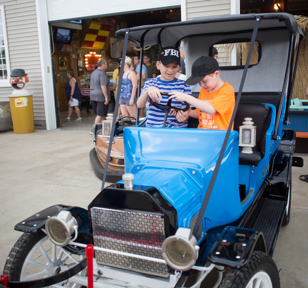 Gabriel Miller, 12, left, and Kershin Salus, 6, both of Austintown, sit in a buggy at the Idora Park experience on Sunday. EMILY MATTHEWS | THE VINDICATOR