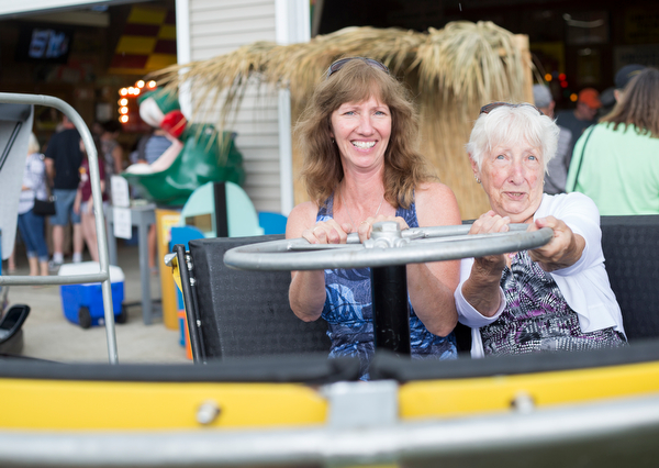 Alice Swarts, left, and Mary Ann Holland, both of Alliance, sit in a replica of the turtle ride at the Idora Park experience on Sunday. EMILY MATTHEWS | THE VINDICATOR