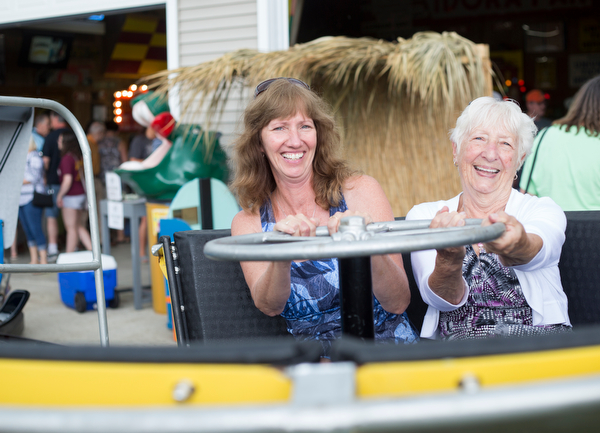 Alice Swarts, left, and Mary Ann Holland, both of Alliance, sit in a replica of the turtle ride at the Idora Park experience on Sunday. EMILY MATTHEWS | THE VINDICATOR