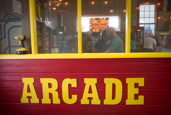 People look at and play some of the games in the arcade replica at the Idora Park experience on Sunday. EMILY MATTHEWS | THE VINDICATOR
