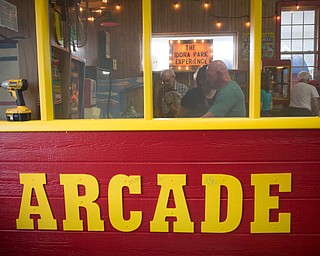 People look at and play some of the games in the arcade replica at the Idora Park experience on Sunday. EMILY MATTHEWS | THE VINDICATOR