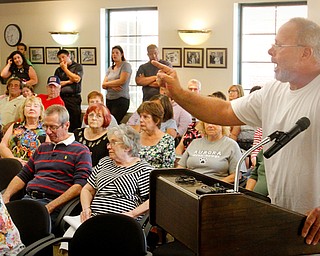 Boardman resident Mike Sprague speaks out at a Boardman Township trustees meeting Monday about storm water problems at his home. Many township residents experienced flooding from recent heavy rains.