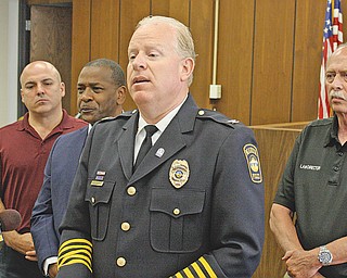 Warren Police Chief Eric Merkel, in front, addressed news media Monday in Warren City Council chambers regarding the likely end of U.S. Justice Department oversight of the Warren Police Department. Others behind him are, from left, Enzo Cantalamessa, Warren safety service director; Mayor Doug Franklin; and Warren Law Director Greg Hicks.