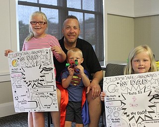 Neighbors | Abby Slanker.Jason Evans, of Boardman, enjoyed some quality time with his children, from left, Jewels, Jacob and Marilyn, at the Canfield library's Donuts with Dad on June 15.