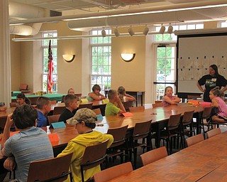 Neighbors | Jessica Harker .Librarian Karen Steed hosted a group of children at the Poland library for the annual Sign Language Camp June 23.