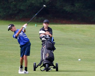 Matthew Morelli, 13, of New Castle, left, hits the ball while C.J. Brew, 12, of Hubbard, watches during the Greatest Golfer junior qualifier at Tam O'Shanter Golf Course in Hermitage, Pa. on Thursday. EMILY MATTHEWS | THE VINDICATOR