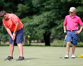 Nathan Kelly, left, of East Liverpool, putts the ball while Anthony Cesario, of Niles, watches during the 14u Greatest Golfer junior qualifier at Tam O'Shanter Golf Course in Hermitage, Pa. on Thursday. EMILY MATTHEWS | THE VINDICATOR