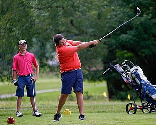 Nathan Kelly, right, of East Liverpool, drives the ball while Anthony Cesario, of Niles, watches during the 14u Greatest Golfer junior qualifier at Tam O'Shanter Golf Course in Hermitage, Pa. on Thursday. EMILY MATTHEWS | THE VINDICATOR