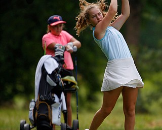 Luciana Masters, 12, of Hermitage, drives the ball while Kate Sowers, 11, of West Middlesex, watches during the Greatest Golfer junior qualifier at Tam O'Shanter Golf Course in Hermitage, Pa. on Thursday. EMILY MATTHEWS | THE VINDICATOR