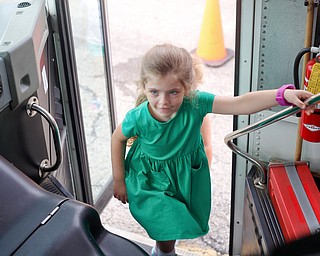 Ainsleigh Varian, an incoming kindergartener, gets on a school bus as part of United Way's Success By 6 program's bus safety day at Stadium Drive Elementary on Tuesday morning. EMILY MATTHEWS | THE VINDICATOR