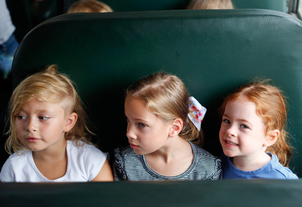 From left, incoming kindergarteners Alice Schumaker, Bexley Jamieson, and Ellie Liebig sit on a school bus as part of United Way's Success By 6 program's bus safety day at Stadium Drive Elementary on Tuesday morning. EMILY MATTHEWS | THE VINDICATOR
