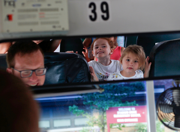 Incoming kindergarteners Alexandria Volsho, right, and Eliza Liebig look at themselves in the rearview mirror as they get off the bus and Ryan Dunn, Boardman's Transportation Supervisor, sits in the drivers seat as part of United Way's Success By 6 program's bus safety day at Stadium Drive Elementary on Tuesday morning. EMILY MATTHEWS | THE VINDICATOR