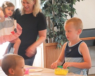 Neighbors | Jessica Harker.Children used colored icing to decorate cookies at the Austintown library for the sugar cookie decorating event.